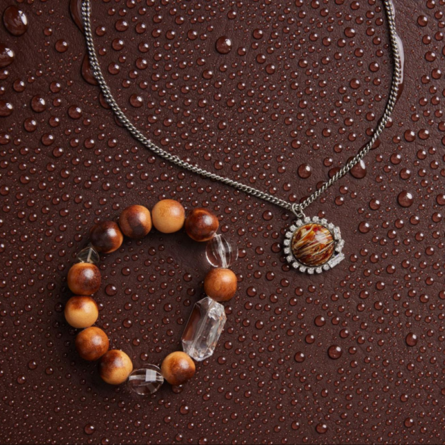 A necklace and bracelet with chunky variegated beads and several small crystals.